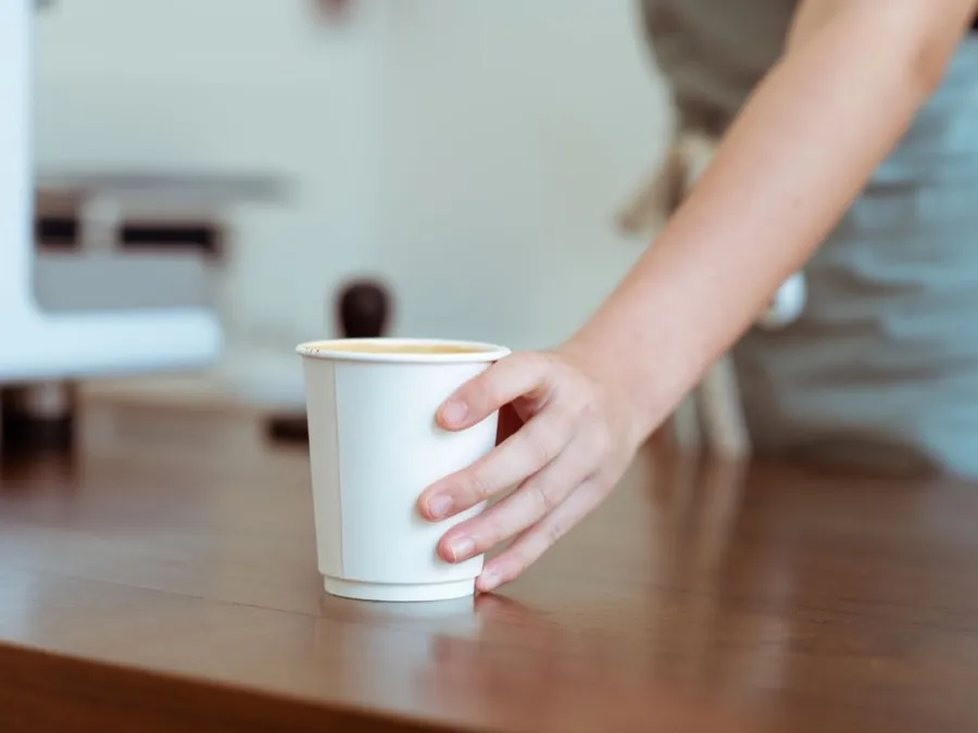 Branded paper coffee cup on a café counter